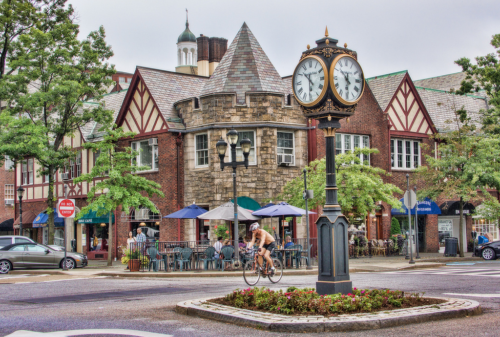 Tudor storefronts, outdoor seating and a village clock in downtown Scarsdale
